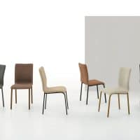 Set di sei sedie moderne con gambe in metallo e basi diverse, in tonalità neutre come grigio, marrone, beige e nero, disposte su sfondo bianco.