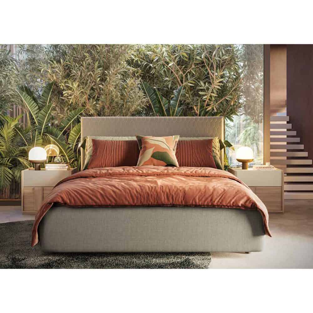 3 Elegante letto imbottito con testiera cappitonné e biancheria in tonalità calde, circondato da piante tropicali e mobili moderni, perfetto per ambienti di design e comfort.
