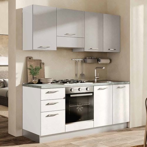 Cucina moderna compatta con ante bianche e piano in acciaio, dotata di forno e piano cottura, ideale per spazi ridotti.