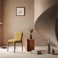 Sedia KANTO in stile contemporaneo in ambiente arredamento moderno con sedia gialla, pareti neutre e scultura curva, ispirato al catalogo Alpe Arredi.