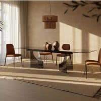 Tavolo FATUM in un ambiente elegante con sedie in pelle e decorazioni minimaliste, perfetto per ambienti moderni e di design.