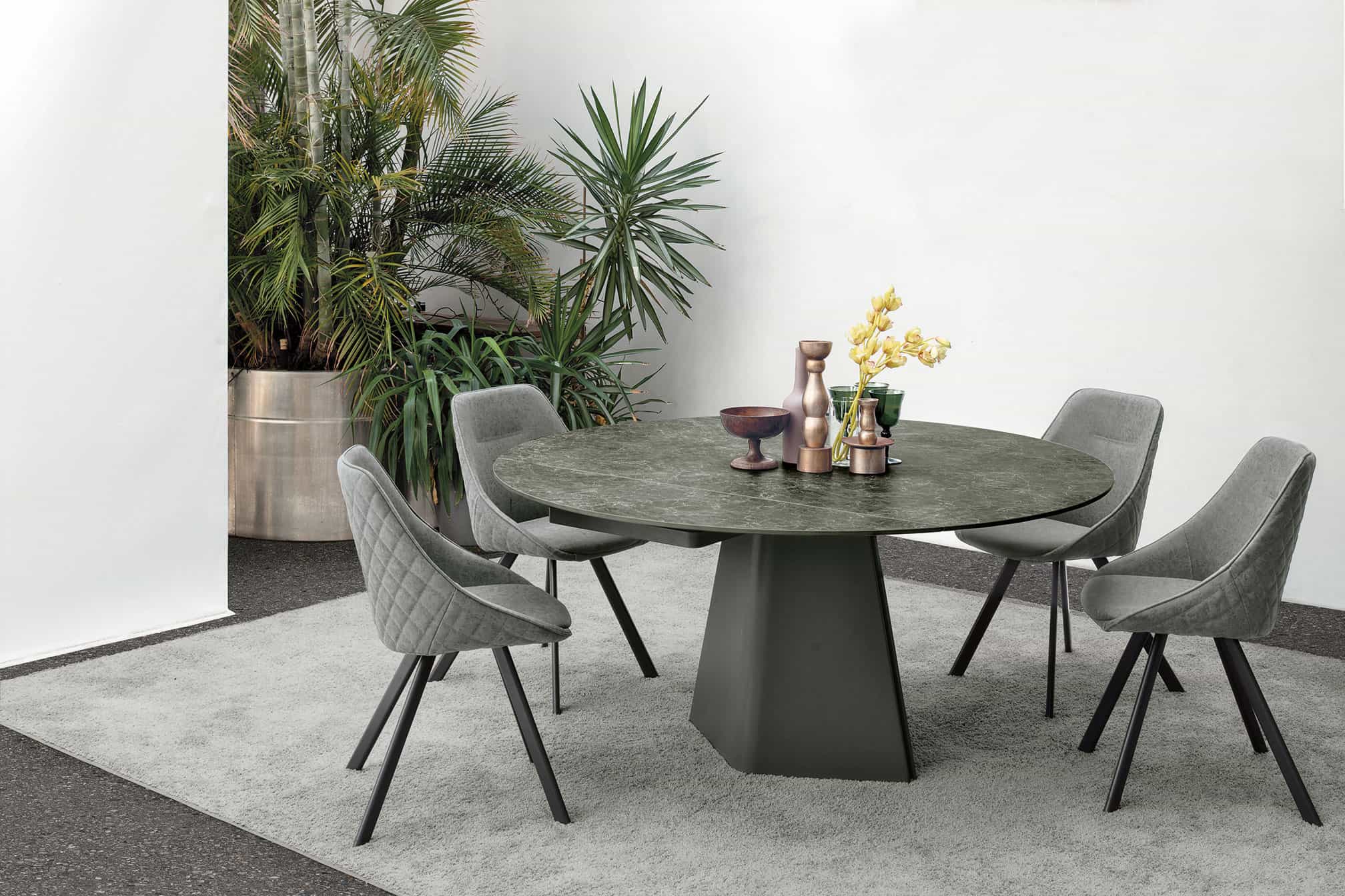 Tavolo TAY di Alpe Arredi con sedie in stile moderno, superficie in pietra e base robusta, ideale per ambienti eleganti e contemporanei.